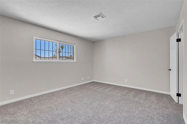 unfurnished room with a textured ceiling, carpet floors, and baseboards