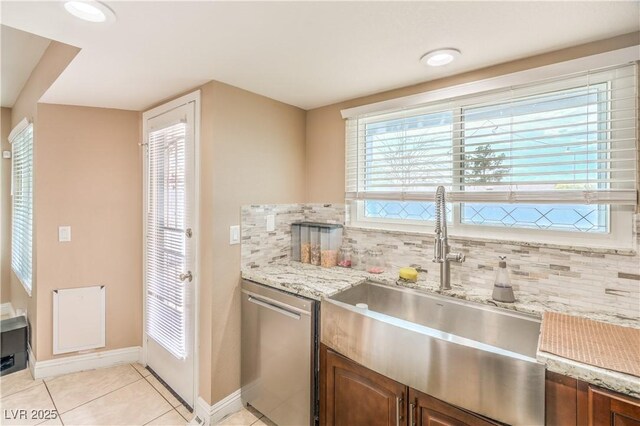 824 Schooner Dr, Henderson, NV 89015 - kitchen with a sink, stainless steel dishwasher, decorative backsplash, and light tile patterned floors