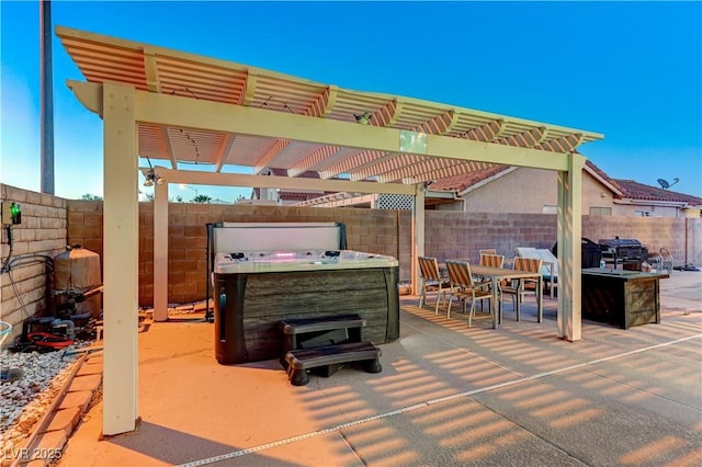 view of patio / terrace featuring a hot tub, a fenced backyard, outdoor dining space, and a pergola