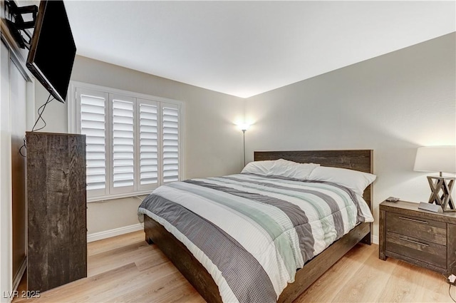 bedroom with wood finished floors and baseboards
