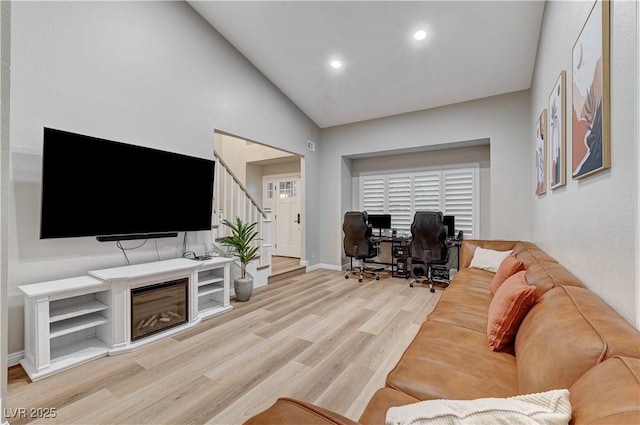 living room with light wood-type flooring, baseboards, an office area, recessed lighting, and stairway