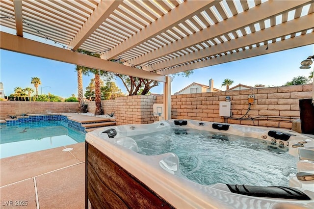 view of pool featuring a fenced backyard and a hot tub