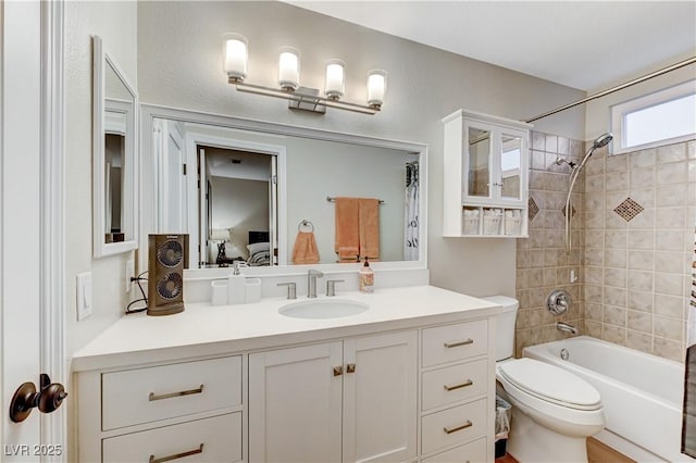 ensuite bathroom with bathing tub / shower combination, vanity, and toilet