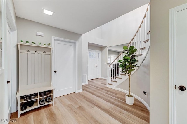 mudroom featuring wood finished floors and baseboards