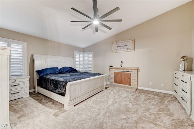 bedroom featuring lofted ceiling, light carpet, baseboards, and a ceiling fan