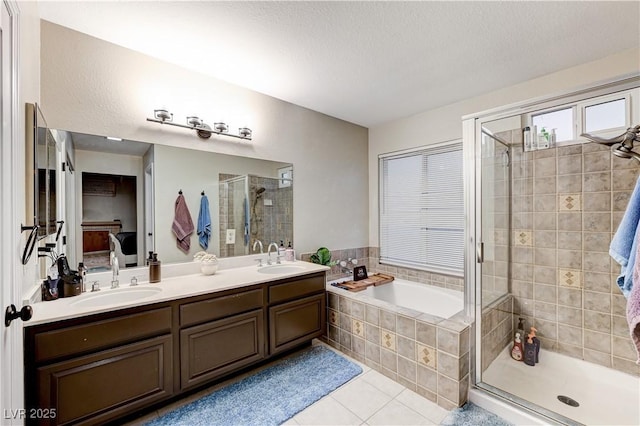 bathroom featuring tile patterned flooring, a shower stall, a bath, and double vanity
