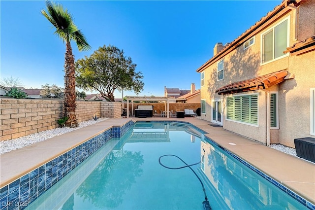 view of swimming pool with a fenced backyard and a patio area