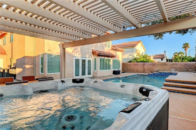 view of pool featuring a hot tub, french doors, and a fenced backyard
