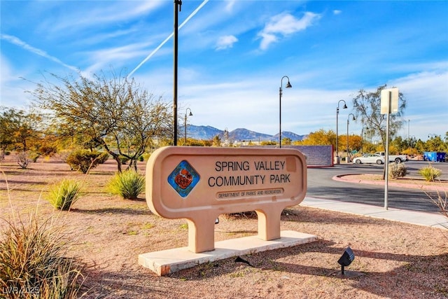community sign with a mountain view
