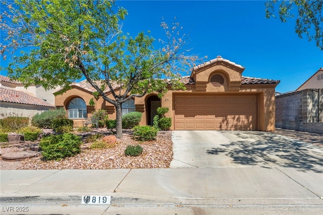 819 Arrowhead Trl, Henderson, NV 89002 - mediterranean / spanish-style home with a tiled roof, an attached garage, stucco siding, and driveway