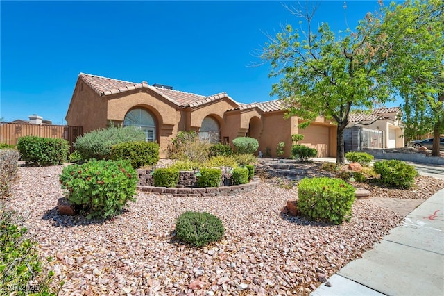 819 Arrowhead Trl, Henderson, NV 89002 - mediterranean / spanish-style house with stucco siding, an attached garage, a tiled roof, and fence
