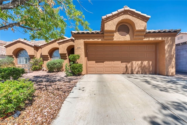 819 Arrowhead Trl, Henderson, NV 89002 - mediterranean / spanish house with a tile roof, stucco siding, and a garage