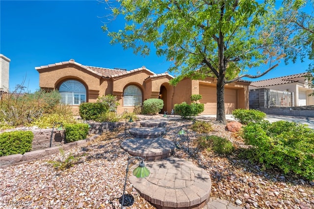 819 Arrowhead Trl, Henderson, NV 89002 - view of front of home featuring stucco siding, a tiled roof, and a garage