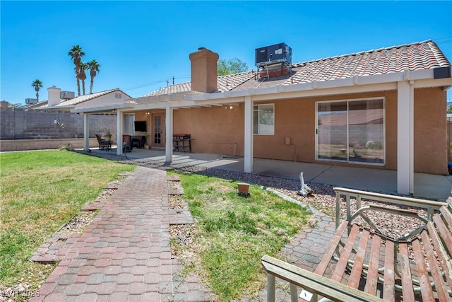 819 Arrowhead Trl, Henderson, NV 89002 - back of house featuring central air condition unit, a patio area, a chimney, and stucco siding