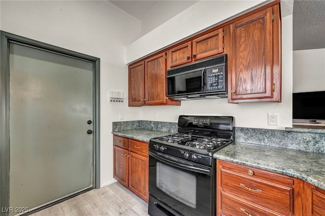 819 Arrowhead Trl, Henderson, NV 89002 - kitchen with black appliances, light wood finished floors, dark countertops, and brown cabinets