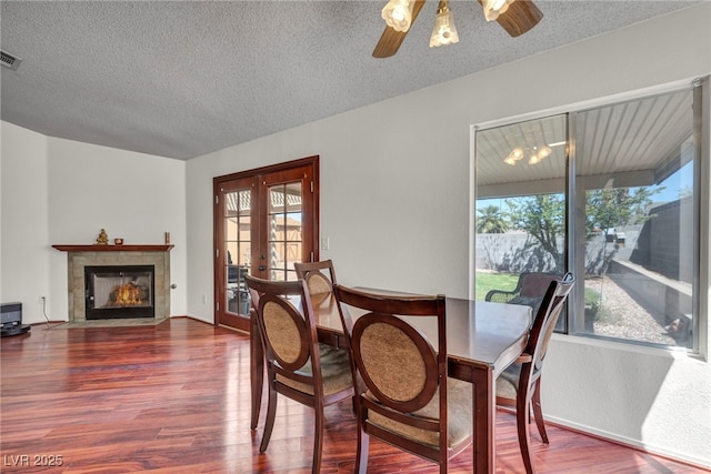 819 Arrowhead Trl, Henderson, NV 89002 - dining area featuring healthy amount of natural light, wood finished floors, ceiling fan, and a textured ceiling