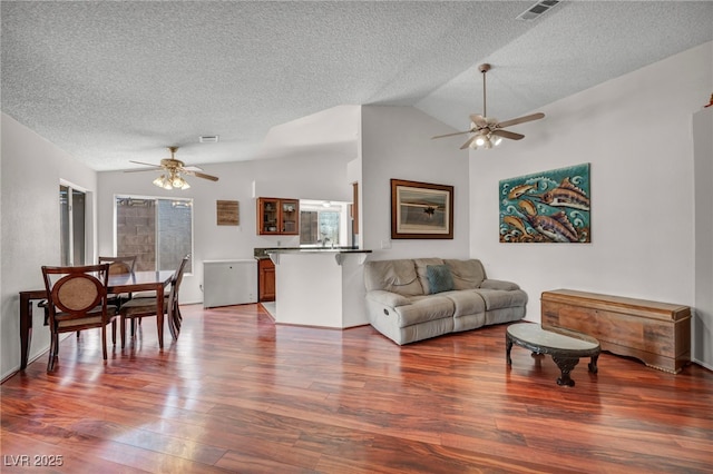 819 Arrowhead Trl, Henderson, NV 89002 - living room featuring ceiling fan, a textured ceiling, wood finished floors, and lofted ceiling