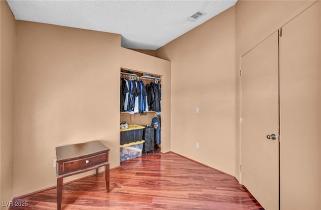 819 Arrowhead Trl, Henderson, NV 89002 - bedroom featuring wood finished floors, a closet, and a textured ceiling