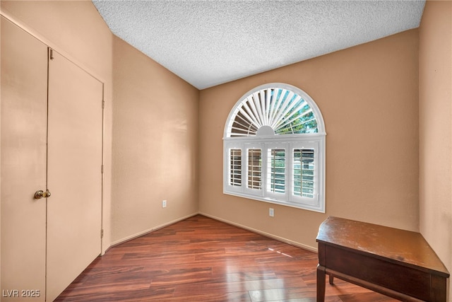 819 Arrowhead Trl, Henderson, NV 89002 - unfurnished bedroom with wood finished floors, a textured ceiling, and baseboards