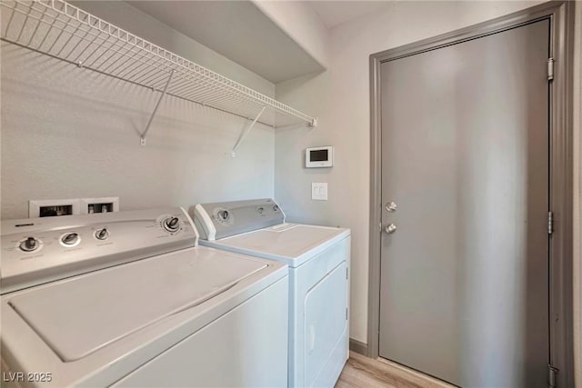 5740 Winter Cherry St, Las Vegas, NV 89130 - laundry room with separate washer and dryer and light wood-style floors