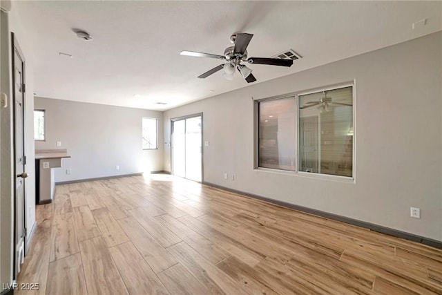 5740 Winter Cherry St, Las Vegas, NV 89130 - unfurnished living room featuring light wood-type flooring, a ceiling fan, and baseboards