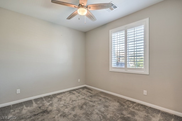carpeted empty room featuring baseboards and a ceiling fan