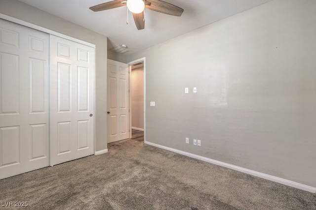 unfurnished bedroom with carpet, a closet, baseboards, and ceiling fan