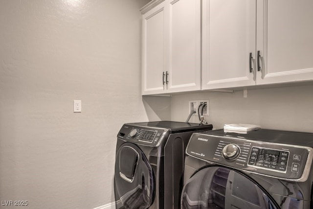 clothes washing area featuring cabinet space, washing machine and dryer, and a textured wall