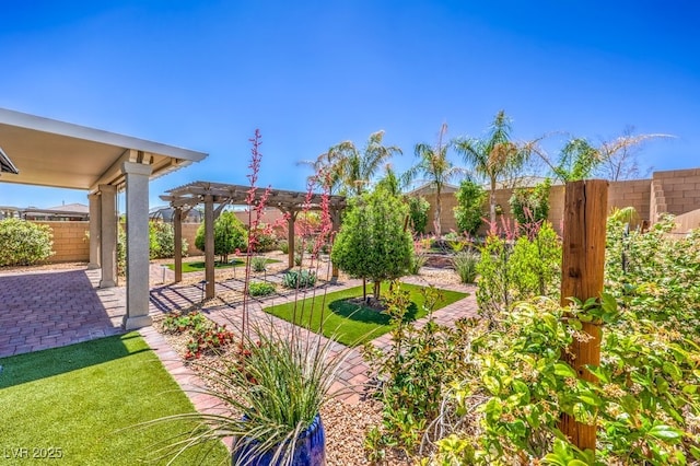 fenced backyard featuring a pergola and a patio