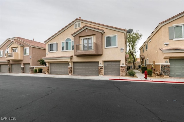 8675 Traveling Breeze Ave Unit 101, Las Vegas, NV 89178 - view of front of home with stucco siding, stone siding, and an attached garage