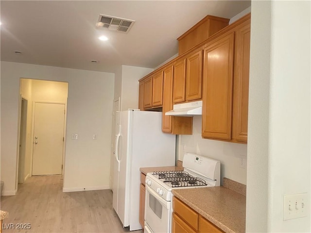 6255 W Arby Ave Unit 239, Las Vegas, NV 89118 - kitchen featuring white range with gas cooktop, under cabinet range hood, light wood finished floors, and baseboards