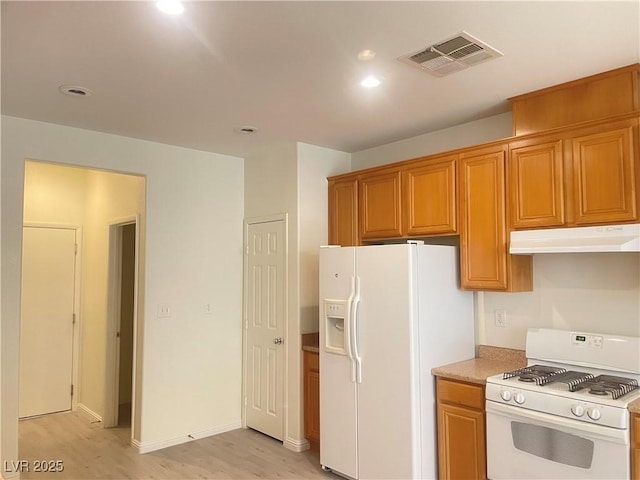6255 W Arby Ave Unit 239, Las Vegas, NV 89118 - kitchen featuring white appliances, under cabinet range hood, light wood-style flooring, recessed lighting, and brown cabinetry