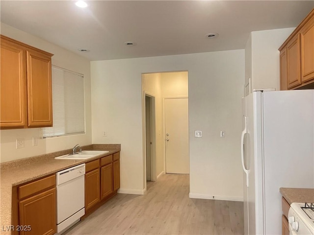 6255 W Arby Ave Unit 239, Las Vegas, NV 89118 - kitchen with white appliances, light wood-style floors, a sink, brown cabinets, and baseboards