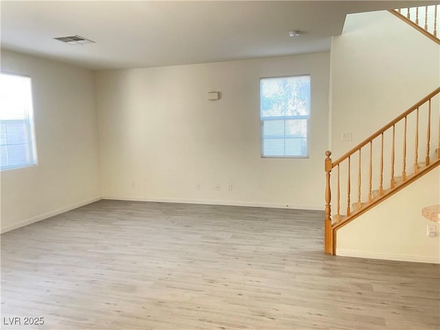 6255 W Arby Ave Unit 239, Las Vegas, NV 89118 - unfurnished living room with stairway, wood finished floors, and baseboards
