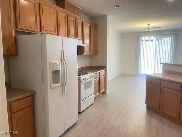 6255 W Arby Ave Unit 239, Las Vegas, NV 89118 - kitchen with white appliances, light wood-style floors, a chandelier, baseboards, and pendant lighting