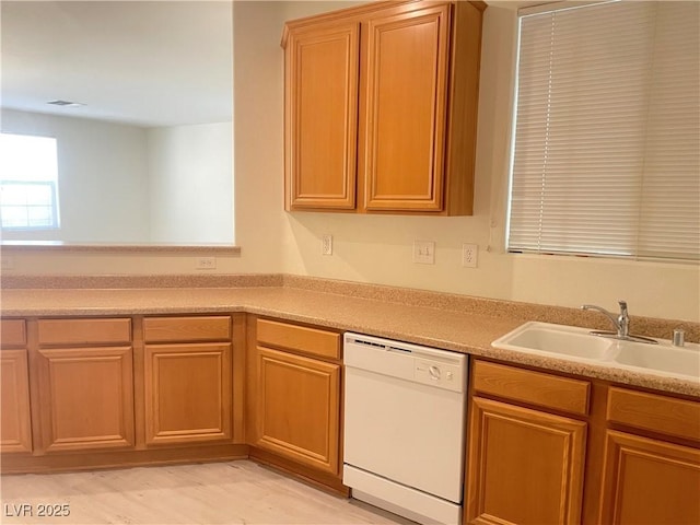 6255 W Arby Ave Unit 239, Las Vegas, NV 89118 - kitchen featuring white dishwasher, a sink, and light countertops