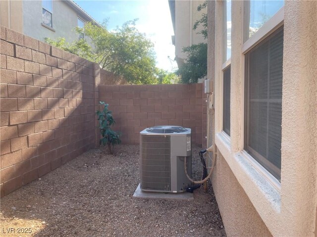 6255 W Arby Ave Unit 239, Las Vegas, NV 89118 - exterior view of central air condition unit, fence, and stucco siding