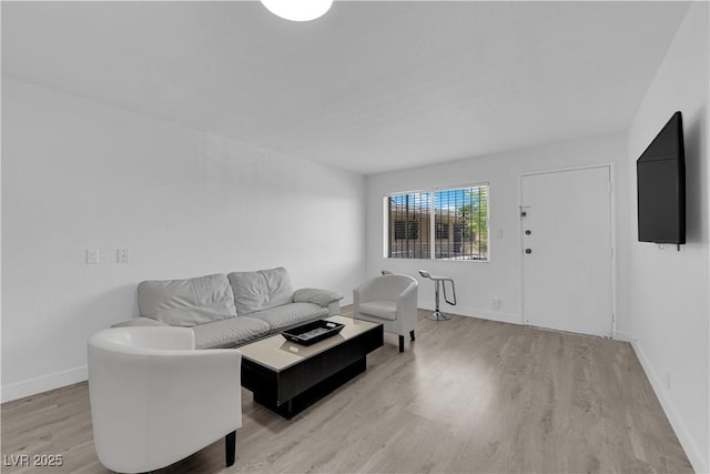 living room with light wood-style flooring and baseboards