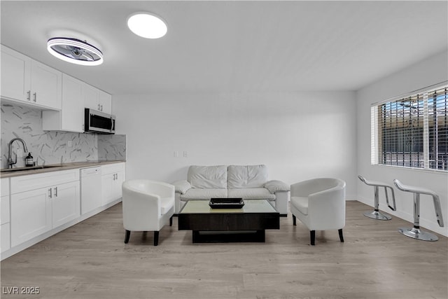 living room featuring light wood finished floors and baseboards