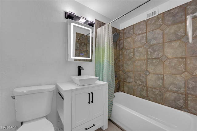 full bath featuring shower / bath combination with curtain, toilet, and vanity