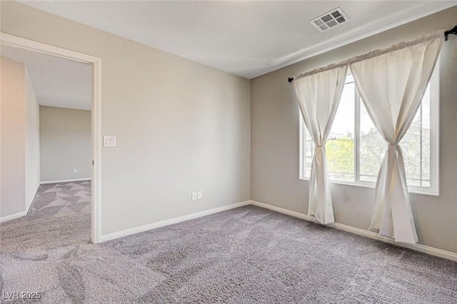carpeted empty room with baseboards