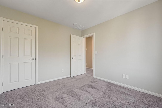 unfurnished bedroom featuring carpet flooring and baseboards