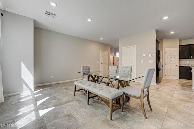 dining room featuring baseboards and recessed lighting
