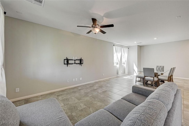 living area featuring a ceiling fan, baseboards, and recessed lighting