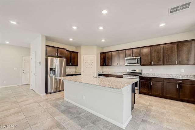 kitchen featuring stainless steel appliances, dark brown cabinets, light stone counters, recessed lighting, and light tile patterned flooring