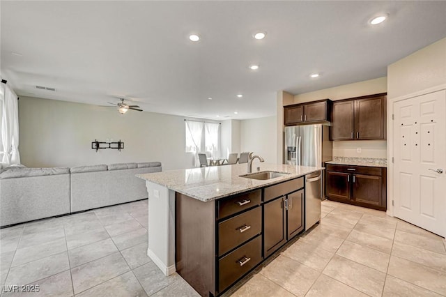 kitchen with a sink, stainless steel appliances, light tile patterned floors, ceiling fan, and recessed lighting