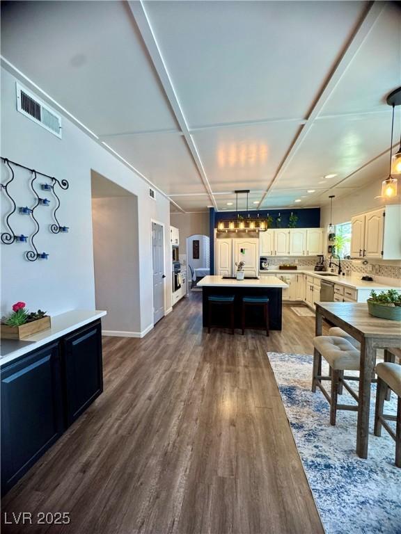 dining room with dark wood-type flooring and baseboards