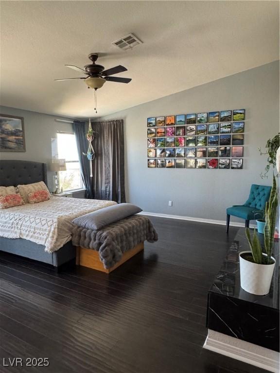 bedroom featuring baseboards, wood finished floors, and a ceiling fan