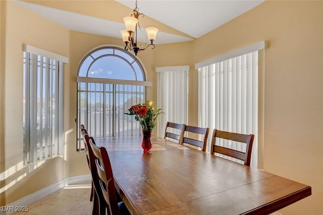 dining area with a chandelier and baseboards