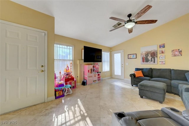 living room with lofted ceiling, ceiling fan, baseboards, and light tile patterned floors